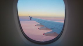 Travel Video View from the Airplane window seat. Twilight view in the early morning reduces speed and landing. Reduce the level of flight to destination with clouds and colorful sky background 