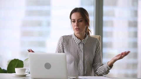 Annoyed stressed businesswoman mad about online problem, failed software application, laptop data loss or stuck computer virus slowing system working with notebook and papers leaving office workplace