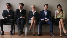Diverse applicants of different age ethnicity waiting for their turn sit in line queue, multi ethnic business people group preparing for job interview, human resources recruitment employment concept - Powered by Shutterstock - Get 15% off with code: PIKWIZARD15