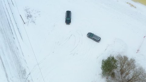 People arriving at a snowy rural location after a long time. Aerial shot of people and dog stepping or jumping out of cars.