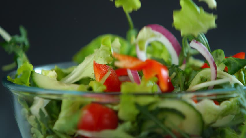 Fresh salad flying to bowl in super slow motion. | Shutterstock HD Video #1022516551