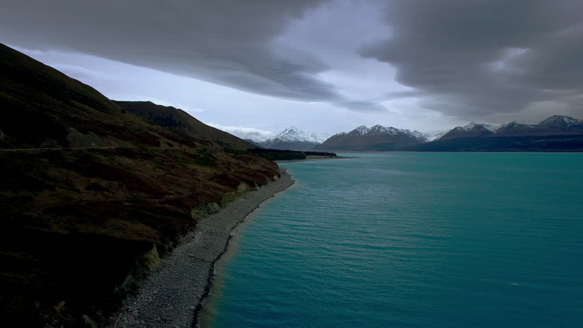 Aerial shot of Mount Cook over Lake Pukaki on a cloudy day in New Zealand.