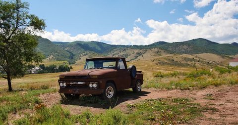 Handheld shot of vintage pickup truck parked in the mountains