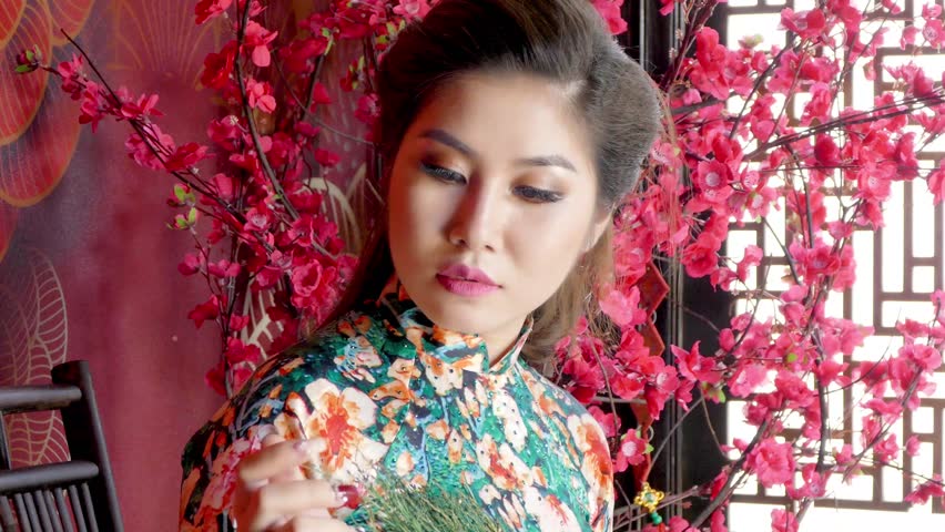 Vietnam girl in the national dress Ao Dai Woman with a bouquet of flowers.