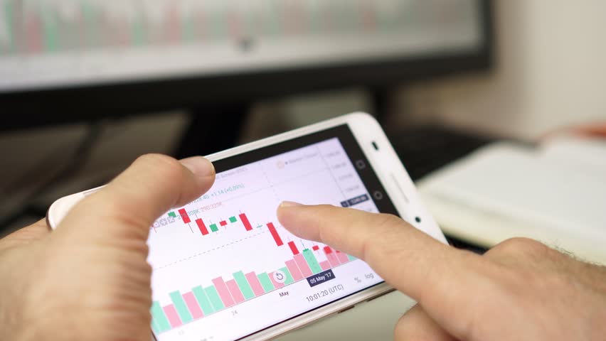 Businessman analyzes the data of the currency or stock exchange using the application on the smartphone. | Shutterstock HD Video #1022523601