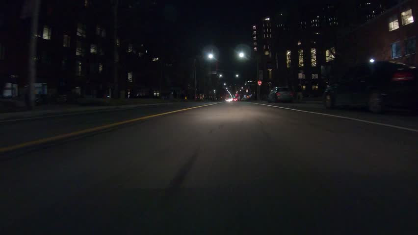 Toronto, Ontario, Canada January 2019 Driving plate POV low angle dark city streets at night with car traffic