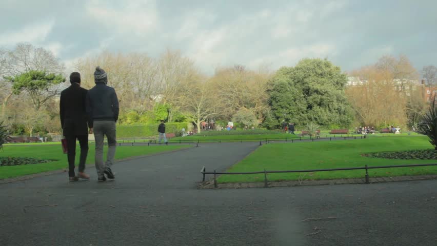 Couple walking through Saint Stephen`s Green Park, Dublin, Ireland