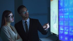 The business couple discussing near the display - Powered by Shutterstock - Get 15% off with code: PIKWIZARD15