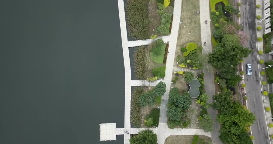 Modern landscape from bird eye view with lake on left side and road on another.