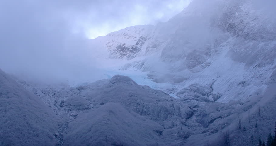 Clouds moving past a glacier and mountain peak in the Chugach mountains Alaska.