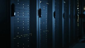 In Dark Data Center: Male IT Specialist Stands Beside the Row of Operational Server Racks, Uses Laptop for Maintenance. Concept for Cloud Computing, Artificial Intelligence, Supercomputer - Powered by Shutterstock - Get 15% off with code: PIKWIZARD15