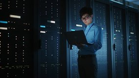 In Dark Data Center: Male IT Specialist Walks along the Row of Operational Server Racks, Uses Laptop for Maintenance. Concept for Cloud Computing, Artificial Intelligence, Supercomputer, Cybersecurity - Powered by Shutterstock - Get 15% off with code: PIKWIZARD15