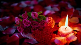 Sprikles rose petals, bouquet and candle burning footage. Decoration Valentine day