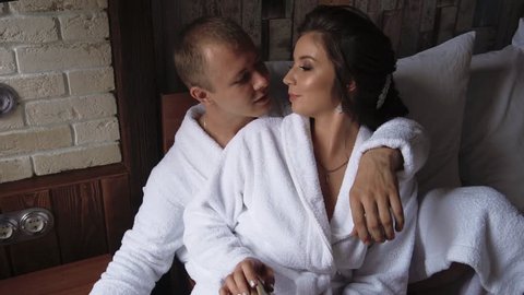 young beautiful couple in the morning getting ready for their indoor wedding, slow motion