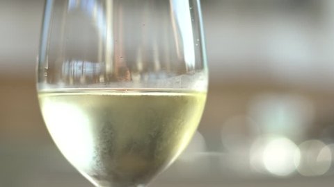 Close Up of women pouring white wine into glass