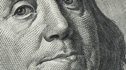 Benjamin Franklin on old US 100 dollar bill slow rotating. 