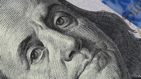 Benjamin Franklin on US 100 dollar bill slow rotating. 