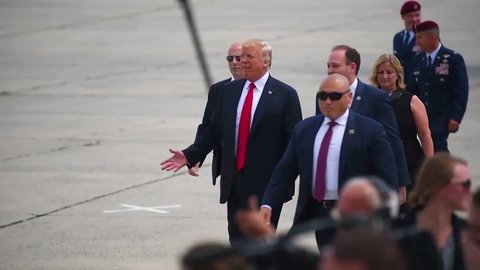 CIRCA 2018 - The President of the United States, Donald J. Trump walks on a tarmac and greets admiring army military personnel at a rally.