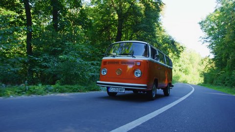 Driving a VW bus on a forest road.