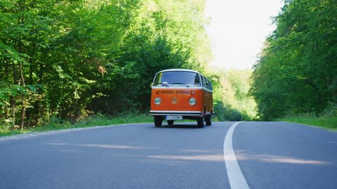 Road trip with an orange VW bus.