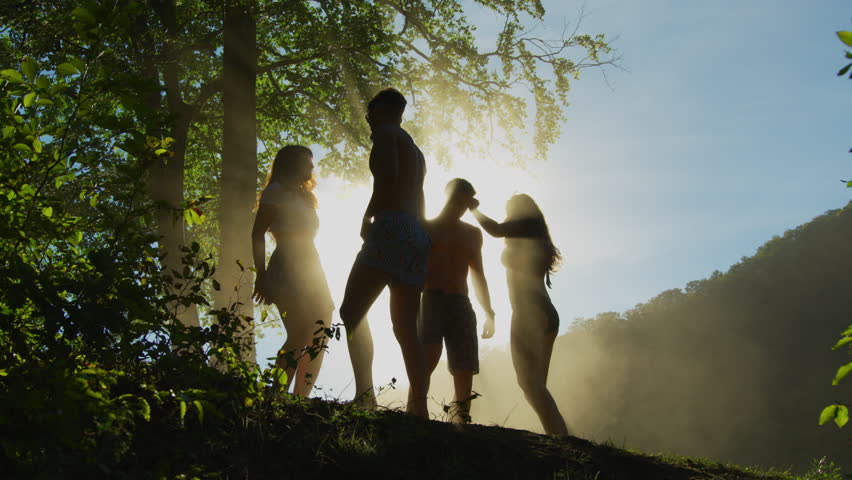 Young people dancing on a hill, on a sunny summer day. | Shutterstock HD Video #1022576494