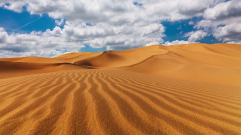 Sunny day over the sand dunes in the desert. 4K TimeLapse