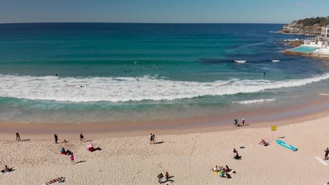 Aerial view of Bondi Beach coastline with surfers, Sydney, Australia.