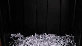 Document shredder with shredded paper falling into a pile  - Powered by Shutterstock - Get 15% off with code: PIKWIZARD15