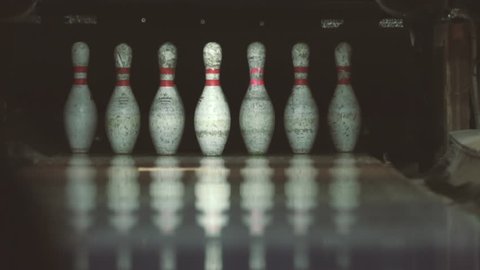 Kiev, Ukraine, January 2019: The ball knocks bowling pins. Game in bowling club. Skittles and bowling ball. Close-up. Activities and entertainment. Outdated Bowling Equipment