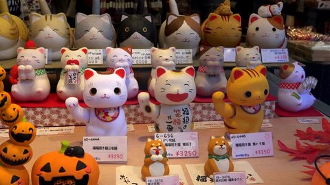 TOKYO, - NOVEMBER 10:
Japanese Beckoning Cats (maneki-neko)  in a shop window. 
November 10, 2018 in Tokyo, Japan 