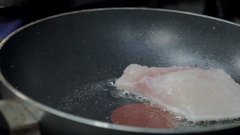 Fish frying in pan