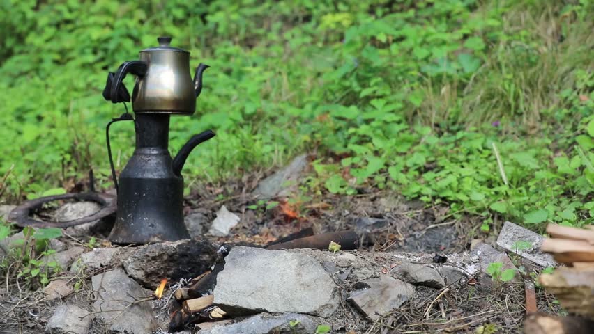 Marching kettle on the bonfire in the woods 