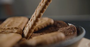 Cookies in slow motion falls on sponge cake. 4K video