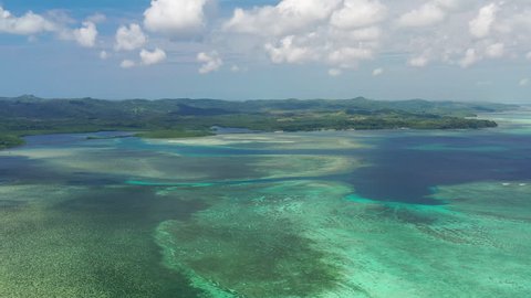 Aerial view of seascape near Ngerulmud, crystal clear waters of Pacific Ocean, colorful coral reefs, many shades of turquoise and blue - landscape panorama of Micronesia from above, Palau