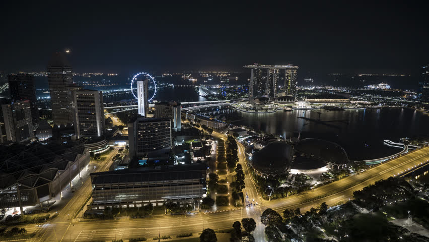 4k time lapse of moon rise night scene at Singapore city skyline. 