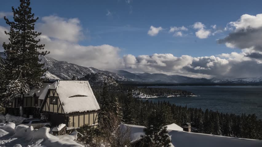 Amazing winter scenery at Lake Tahoe Nevada / California. Timelapse of the next snow storm / blizzard coming in. View from the mountain at Zephyr Cove down to Lake Tahoe with cottage in foreground.