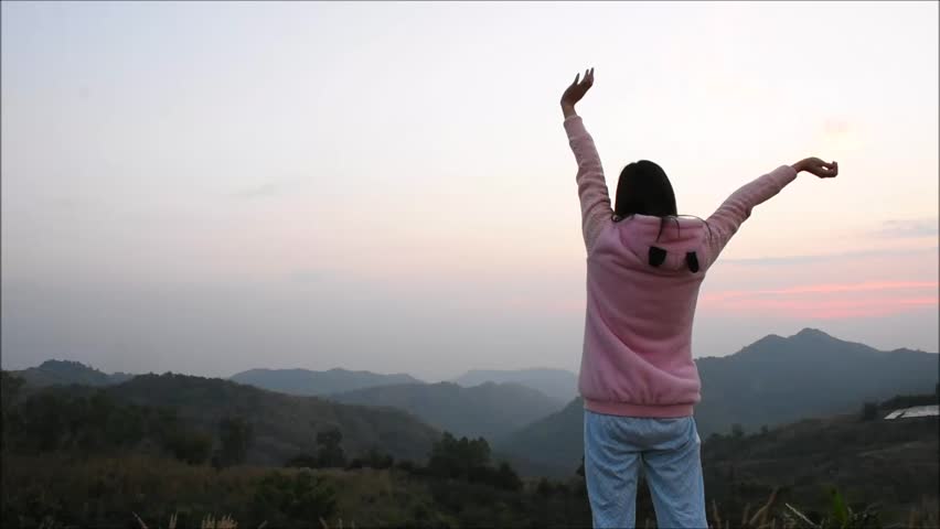 Young girl are relax with landscape view of green mountain in the morning, Back side of girl are exercise on the peak of mountain with mountain view and sunrise sky, Landscape nature in Thailand | Shutterstock HD Video #1022605810