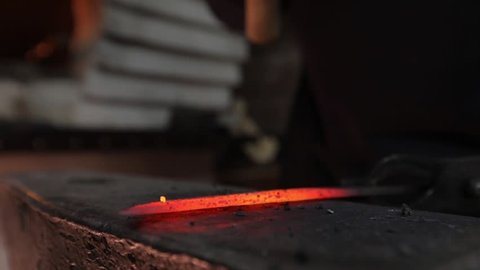 Making a knife from hot steel. Slow motion
