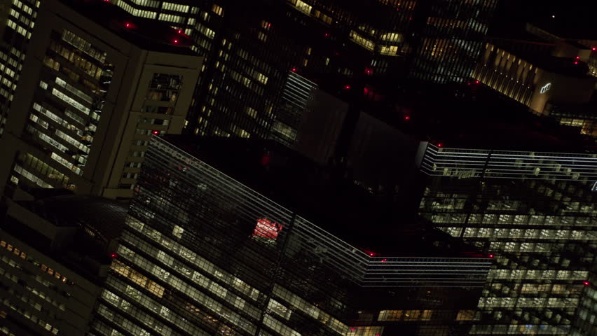 Tokyo, Japan circa-2018. Angled aerial view of Tokyo skyscrapers at night. Shot from helicopter with RED camera.