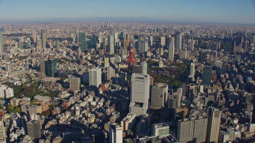 Tokyo, Japan circa-2018. Flying over city of Tokyo and Tokyo Tower. Shot from helicopter with RED camera.