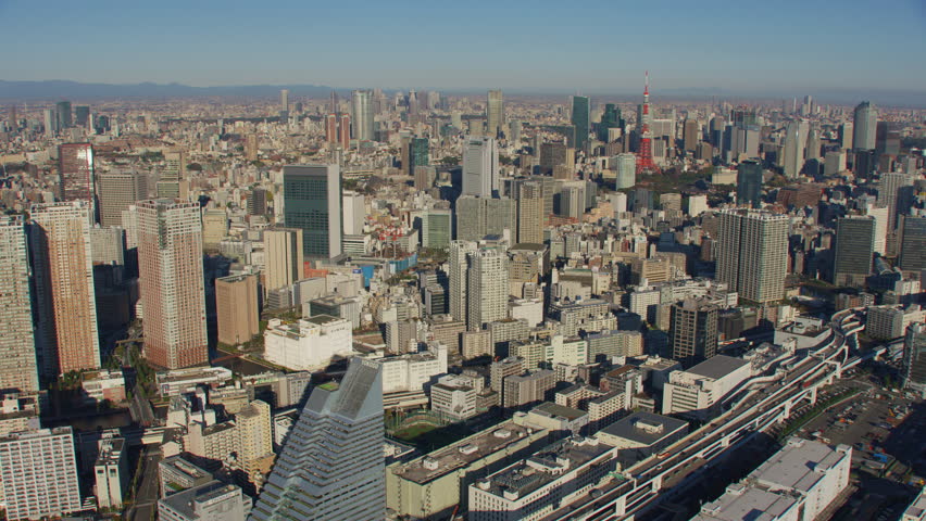 Tokyo, Japan circa-2018. Flying over city of Tokyo and Tokyo Tower. Shot from helicopter with RED camera.