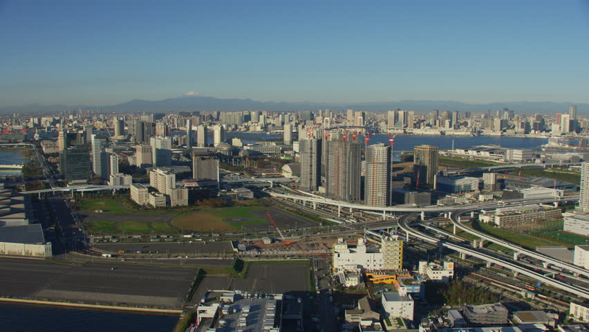 Tokyo, Japan circa-2018. Flying over construction cranes towards Rainbow Bridge and city. Shot from helicopter with RED camera.