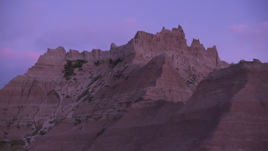 Driving through Badlands National Park at sunset, South Dakota