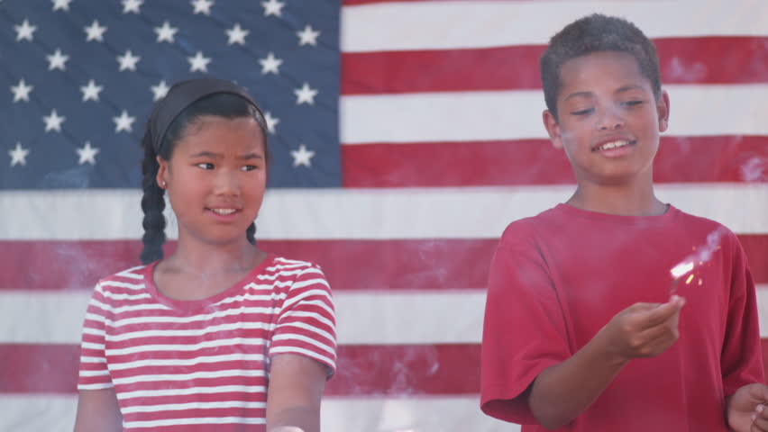 Kids with sparklers on Fourth of July