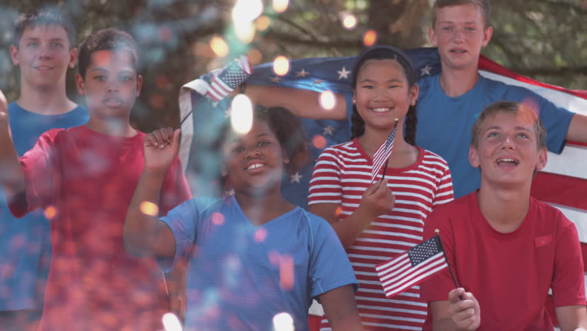 Kids watching fireworks and waving flags on Fourth of July