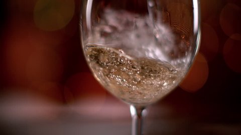 Super slow motion of pouring white wine into glass. Filmed on high speed cinema camera, 1000 fps.
