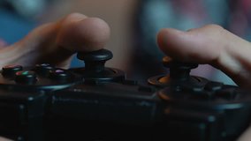 Males hands holding joystick, playing video game and having fun, close up
