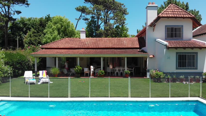 Exterior of suburban home with pool and lawn