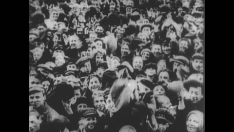 RUSSIA 1910s: Crowd cheers / Leon Trotsky waves / Pan of crowd / Vladimir Lenin speaks / Photo of Lenin with Joseph Stalin / Stalin seated.