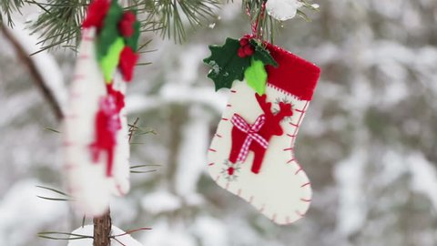 sock and mittens with Christmas pattern hanging and dying on the clothesline
